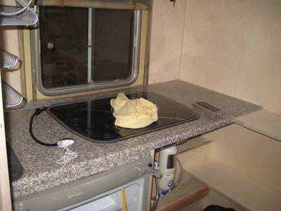 Küche mit 2 Flammenkocher und Spüle, mit Glas abklappbar. Es liegt noch eine leselampe drauf, die noch verbaut werden darf